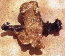 This is an ankle bone of an individual who was crucified.  The nail must have bent when it was driven into the wood of the cross.  